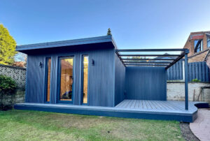 The exterior of the garden room has been clad with slatted composite cladding with colour matched decking