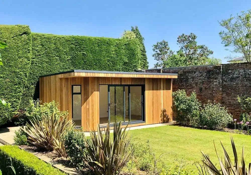 The angled wall softens the building in the garden